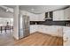 Bright kitchen featuring white cabinets, stainless steel appliances, and a modern black backsplash at 2685 S Tenaya Way, Las Vegas, NV 89117