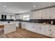 Bright kitchen with white cabinets, stainless appliances, and a marble countertop island at 2685 S Tenaya Way, Las Vegas, NV 89117