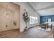 Open-concept living room with wood floors, high ceilings, and a large window at 2685 S Tenaya Way, Las Vegas, NV 89117