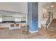 Open-concept living space with wood floors connecting the dining area, kitchen, and foyer at 2685 S Tenaya Way, Las Vegas, NV 89117