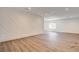 Stylish living room boasts unique accent wall and wood-look flooring at 2685 S Tenaya Way, Las Vegas, NV 89117