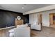 Bright living room featuring modern furnishings, sleek wood floors and paneled accent wall at 2685 S Tenaya Way, Las Vegas, NV 89117