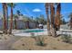 Backyard pool area featuring desert landscaping, a diving board, and lounge chairs, creating a private oasis at 2685 S Tenaya Way, Las Vegas, NV 89117