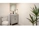 Cozy powder room with modern fixtures, tiled floor and decorative houseplant at 2685 S Tenaya Way, Las Vegas, NV 89117