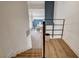 Wood staircase descending, provides an open view of the dining and living area at 2685 S Tenaya Way, Las Vegas, NV 89117