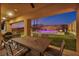 Covered patio with outdoor dining area overlooking a gorgeous pool and landscaped yard at 270 Shaded Canyon Dr, Henderson, NV 89012