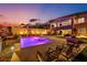 Enjoy the backyard with a sparkling pool, spa, seating area, and covered outdoor living space at 270 Shaded Canyon Dr, Henderson, NV 89012