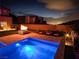 Backyard oasis with sparkling pool, fire pit, comfortable seating, and panoramic city views at 270 Shaded Canyon Dr, Henderson, NV 89012
