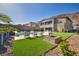 Spacious backyard featuring a pool, fire pit, lounge chairs, and well-maintained landscaping at 270 Shaded Canyon Dr, Henderson, NV 89012