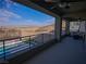 Enjoy panoramic mountain views from this expansive balcony with comfortable seating and a sleek railing at 270 Shaded Canyon Dr, Henderson, NV 89012