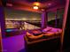 Relax on this covered balcony at night, featuring cozy seating and stunning city light views at 270 Shaded Canyon Dr, Henderson, NV 89012