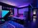 Unique bar and entertainment area with vibrant lighting, modern bar stools, and fun decor at 270 Shaded Canyon Dr, Henderson, NV 89012