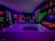 Unique bar and entertainment area with vibrant lighting, modern bar stools, and fun decor at 270 Shaded Canyon Dr, Henderson, NV 89012