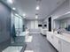 A spacious bathroom with a glass shower, soaking tub, double sink vanity, and contemporary tile flooring at 270 Shaded Canyon Dr, Henderson, NV 89012