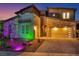 Modern home showcasing unique architectural details, professional lighting, and a well-maintained driveway at 270 Shaded Canyon Dr, Henderson, NV 89012
