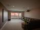 Cozy living room with a large screen, projector, comfortable sofa, and sliding glass doors to enjoy the outdoor view at 270 Shaded Canyon Dr, Henderson, NV 89012