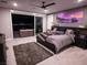 Spacious main bedroom boasts a plush bed, scenic views, and access to a private outdoor balcony at 270 Shaded Canyon Dr, Henderson, NV 89012