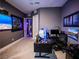 Home office area featuring a modern desk, comfortable chair, and wall-mounted displays for a productive workspace at 270 Shaded Canyon Dr, Henderson, NV 89012