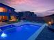 Backyard pool and spa area with outdoor seating and beautiful sunset views at 270 Shaded Canyon Dr, Henderson, NV 89012