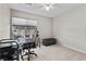 A home office features a window, desk, chair, and ottoman at 2716 Timber Crossing Ct, Henderson, NV 89074