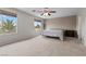 Bright and airy main bedroom with palm tree views from large windows at 2716 Timber Crossing Ct, Henderson, NV 89074