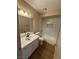 This bathroom includes an updated vanity, mirror and shower with a bathtub at 2750 S Durango Dr # 1080, Las Vegas, NV 89117