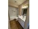 Updated bathroom featuring a shower-tub combo, modern vanity, and wood-look flooring at 2750 S Durango Dr # 1080, Las Vegas, NV 89117