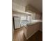 Galley kitchen featuring white cabinetry, granite countertops and modern appliances at 2750 S Durango Dr # 1080, Las Vegas, NV 89117