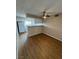 Open kitchen with a breakfast bar and white appliances over wood-look floors at 2750 S Durango Dr # 1080, Las Vegas, NV 89117
