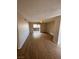 Cozy living room with neutral walls and wood-look floors featuring a sliding door for natural light at 2750 S Durango Dr # 1080, Las Vegas, NV 89117
