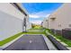 A backyard featuring trampolines and synthetic lawns, bordered by pavers creating a modern recreational area at 2787 La Bella Ct, Henderson, NV 89052