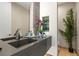Modern bathroom featuring a sleek vanity, stylish faucet, and artistic decor with plants and minimalist design at 2787 La Bella Ct, Henderson, NV 89052