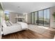 Bright bedroom featuring two beds, a walkout balcony, and sleek wood-look flooring at 2787 La Bella Ct, Henderson, NV 89052