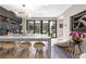 Elegant dining area with modern chandelier, unique seating, and sliding doors to outdoor patio, ideal for entertaining at 2787 La Bella Ct, Henderson, NV 89052