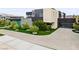 Striking modern home with a clean architectural design, lush lawn, and gray exterior accents at 2787 La Bella Ct, Henderson, NV 89052