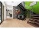 Entertaining game room with poker table, floating stairs, and adjacent media room for ultimate relaxation at 2787 La Bella Ct, Henderson, NV 89052