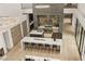 Open-concept living area with dining and kitchen areas under high ceilings and bright, natural light at 2787 La Bella Ct, Henderson, NV 89052