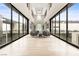 Grand hallway with high ceilings, floor-to-ceiling windows, and modern seating at 2787 La Bella Ct, Henderson, NV 89052