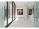Bright hallway features modern art and large windows offering abundant natural light at 2787 La Bella Ct, Henderson, NV 89052
