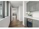Hallway with built-in bar and wine refrigerator featuring wood-look tile floors and recessed lights at 2787 La Bella Ct, Henderson, NV 89052
