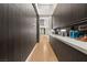 Long hallway with sleek, modern cabinets and a glimpse into the home's bright interior at 2787 La Bella Ct, Henderson, NV 89052