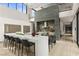 Modern kitchen with island seating, stone accent wall, and sleek appliances at 2787 La Bella Ct, Henderson, NV 89052