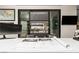 Contemporary office featuring a sleek desk, modern art, and sliding doors to a balcony with scenic views at 2787 La Bella Ct, Henderson, NV 89052