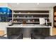Home office with a custom built-in shelving unit and a sleek desk for workspace and organization at 2787 La Bella Ct, Henderson, NV 89052