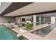 A modern outdoor space with an infinity pool and elegant lounge furniture at 2787 La Bella Ct, Henderson, NV 89052