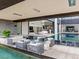 Expansive outdoor pool area with contemporary seating, seamlessly blending indoor/outdoor living at 2787 La Bella Ct, Henderson, NV 89052