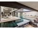 Infinity pool with a sunken outdoor living space overlooking the modern home at 2787 La Bella Ct, Henderson, NV 89052