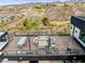Elevated rooftop deck with cozy seating, dining, and fire pit overlooking serene desert landscape with golf course views at 2787 La Bella Ct, Henderson, NV 89052