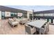 Spacious rooftop deck featuring ample seating, a dining table, and a cozy fire pit with city views at 2787 La Bella Ct, Henderson, NV 89052