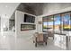 Sitting area featuring fireplace, TV, and view to exterior spiral staircase at 2787 La Bella Ct, Henderson, NV 89052